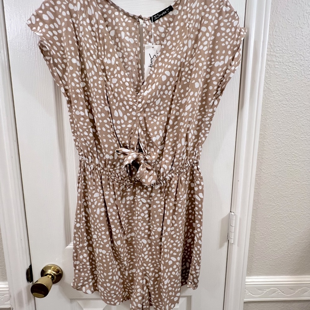 Romper beige/white with cutout, size large.